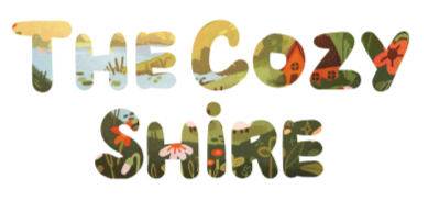 The Cozy Shire logo The design features the words 'the cozy shire' in a bubble font with nature art inside the letters